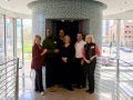 CBB board members pose with bank president Amy Lemar and Lee Bey in the round elevator